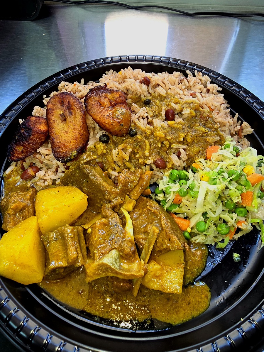 Curry goat with rice and peas